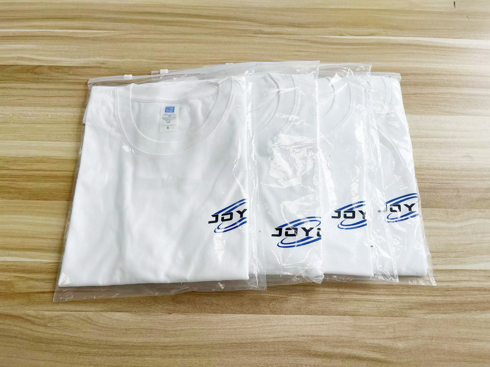 White t-shirts with blue “JOYO” logo