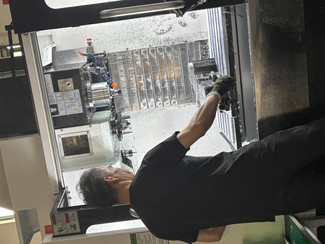worker operate the CNC machine